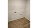 Laundry room with wood-style flooring and washer and dryer hookups at 221 Eleanora Way, Loganville, GA 30052