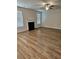 Spacious living room with a fireplace, ceiling fan, and bright windows at 221 Eleanora Way, Loganville, GA 30052
