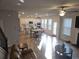 Open-concept layout with a kitchen, living room, and dining area filled with natural light at 221 Eleanora Way, Loganville, GA 30052