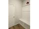 Bright mudroom features built-in bench with storage and a door for convenient access at 221 Eleanora Way, Loganville, GA 30052