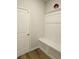 Functional mudroom area with built-in bench, storage, and door to the garage at 221 Eleanora Way, Loganville, GA 30052