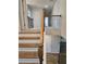 Staircase with wood and metal railings leading to the upper level landing at 221 Eleanora Way, Loganville, GA 30052