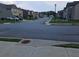 Street view featuring well-maintained homes and landscaping with smooth asphalt roadway at 221 Eleanora Way, Loganville, GA 30052