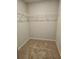 Walk-in closet featuring built-in shelving and carpet flooring at 221 Eleanora Way, Loganville, GA 30052