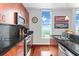 Bright kitchen with black tile backsplash, stainless steel appliances, sleek countertops, and wooden cabinetry at 250 Pharr Ne Rd # 1914, Atlanta, GA 30305