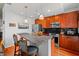 Kitchen with granite island, bar stool seating, stainless steel appliances, and warm wood cabinetry at 250 Pharr Ne Rd # 1914, Atlanta, GA 30305