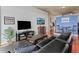 Living room boasts a stylish entertainment center, black leather sofa, and open layout leading to a dining area at 250 Pharr Ne Rd # 1914, Atlanta, GA 30305