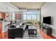 Contemporary living room with a black leather sofa, sleek furniture, and city views from the large windows at 250 Pharr Ne Rd # 1914, Atlanta, GA 30305