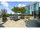 Outdoor kitchen and dining area with modern grill, table, and seating, perfect for entertaining with city views at 250 Pharr Ne Rd # 1914, Atlanta, GA 30305