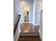 Hallway view of bathroom with gray vanity, framed mirror, and modern lighting at 4487 Kerrington Ave, Sugar Hill, GA 30518