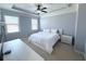 Bedroom with neutral paint, a large television and two windows at 4487 Kerrington Ave, Sugar Hill, GA 30518
