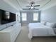 Bedroom has two windows, neutral paint, a television and tray ceiling at 4487 Kerrington Ave, Sugar Hill, GA 30518