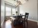 Bright dining room with large windows, modern light fixture, and seating for six at 4487 Kerrington Ave, Sugar Hill, GA 30518