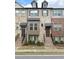 Charming townhome featuring a brick facade, inviting entrance, and well-maintained landscaping at 4487 Kerrington Ave, Sugar Hill, GA 30518