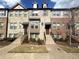 Attractive townhome featuring a brick facade, inviting entrance, and well-maintained landscaping at 4487 Kerrington Ave, Sugar Hill, GA 30518