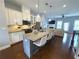 Spacious open kitchen featuring granite countertops, stainless steel appliances, and a large island with bar seating at 4487 Kerrington Ave, Sugar Hill, GA 30518
