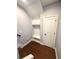Mudroom features storage and seating with a built-in bench and coat hooks next to an interior door at 4487 Kerrington Ave, Sugar Hill, GA 30518