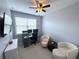 Home office with a desk, computer and two comfortable sitting chairs at 4487 Kerrington Ave, Sugar Hill, GA 30518