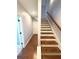 The staircase features wood steps and white risers, along with a hardwood landing at 4487 Kerrington Ave, Sugar Hill, GA 30518