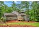 Exterior view of the home's rear featuring a screened-in porch and a wooden deck surrounded by lush landscaping at 4536 Mountain Creek Ne Dr, Roswell, GA 30075