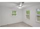 Bedroom featuring neutral carpet, ceiling fan, and two windows at 4536 Mountain Creek Ne Dr, Roswell, GA 30075