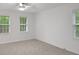Bright, spacious bedroom with plush carpeting and abundant natural light from two windows at 4536 Mountain Creek Ne Dr, Roswell, GA 30075