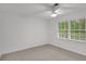 Bedroom with neutral carpet, ceiling fan, and windows at 4536 Mountain Creek Ne Dr, Roswell, GA 30075