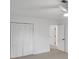 Bedroom featuring closet with louvered doors, neutral carpet, and a ceiling fan at 4536 Mountain Creek Ne Dr, Roswell, GA 30075