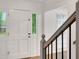 Foyer featuring an entry door with sidelight and staircase with gray banister at 4536 Mountain Creek Ne Dr, Roswell, GA 30075