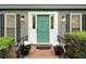 The home's entryway features a light teal front door with white trim flanked by windows and flower boxes at 4536 Mountain Creek Ne Dr, Roswell, GA 30075