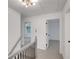 Upstairs hallway featuring neutral carpet, modern lighting, and doors to rooms at 4536 Mountain Creek Ne Dr, Roswell, GA 30075
