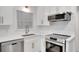 Modern kitchen featuring stainless steel appliances, including range and microwave at 4536 Mountain Creek Ne Dr, Roswell, GA 30075