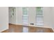 Living room with hardwood floors, a bright window, and a white door at 4536 Mountain Creek Ne Dr, Roswell, GA 30075