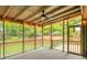 Inviting screened-in porch with a ceiling fan, string lights, and a view of the lush green backyard at 4536 Mountain Creek Ne Dr, Roswell, GA 30075
