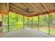 Outdoor screened porch featuring carpet, a ceiling fan and views of the lush, wooded yard at 4536 Mountain Creek Ne Dr, Roswell, GA 30075