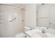 All-white bathroom complete with shower, vanity, and mirror at 538 First St, Lawrenceville, GA 30046