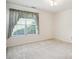 This bedroom is spacious with bright carpet and large window with curtains at 538 First St, Lawrenceville, GA 30046