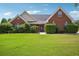 Charming brick home with lush green lawn and manicured bushes in a residential neighborhood at 538 First St, Lawrenceville, GA 30046