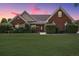 Beautiful brick home featuring a green lawn, professional shrubbery and a modern front door at 538 First St, Lawrenceville, GA 30046