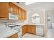 Well-lit kitchen featuring classic cabinets, white appliances, and cozy dining space at 538 First St, Lawrenceville, GA 30046