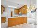 Bright kitchen with wooden cabinets, white counters, island, and an open view to the living area at 538 First St, Lawrenceville, GA 30046