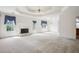 Bright living room with fireplace, trey ceiling, elegant chandelier, and large windows at 538 First St, Lawrenceville, GA 30046