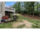 A spacious backyard features a deck, lush lawn, and a treed boundary for added privacy at 139 Ardsley Run, Canton, GA 30115