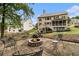 A landscaped backyard features a stone fire pit and patio that offers ample room for outdoor entertaining at 139 Ardsley Run, Canton, GA 30115