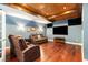 Cozy basement with hardwood floors, plush seating, and a large flat-screen TV for entertainment at 139 Ardsley Run, Canton, GA 30115