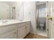 Bright bathroom featuring double sinks, white cabinetry, and separate toilet area for added convenience at 139 Ardsley Run, Canton, GA 30115