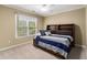 Bedroom featuring a bed frame with storage, soft carpet, and a window at 139 Ardsley Run, Canton, GA 30115