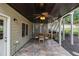 Charming covered patio with tile flooring, ceiling fans, and serene garden views, ideal for outdoor gatherings at 139 Ardsley Run, Canton, GA 30115