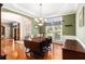 Elegant dining room with hardwood floors, chandelier, and large window overlooking the backyard at 139 Ardsley Run, Canton, GA 30115