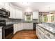 Updated kitchen boasting granite countertops, stainless steel appliances, and ample cabinet space at 139 Ardsley Run, Canton, GA 30115